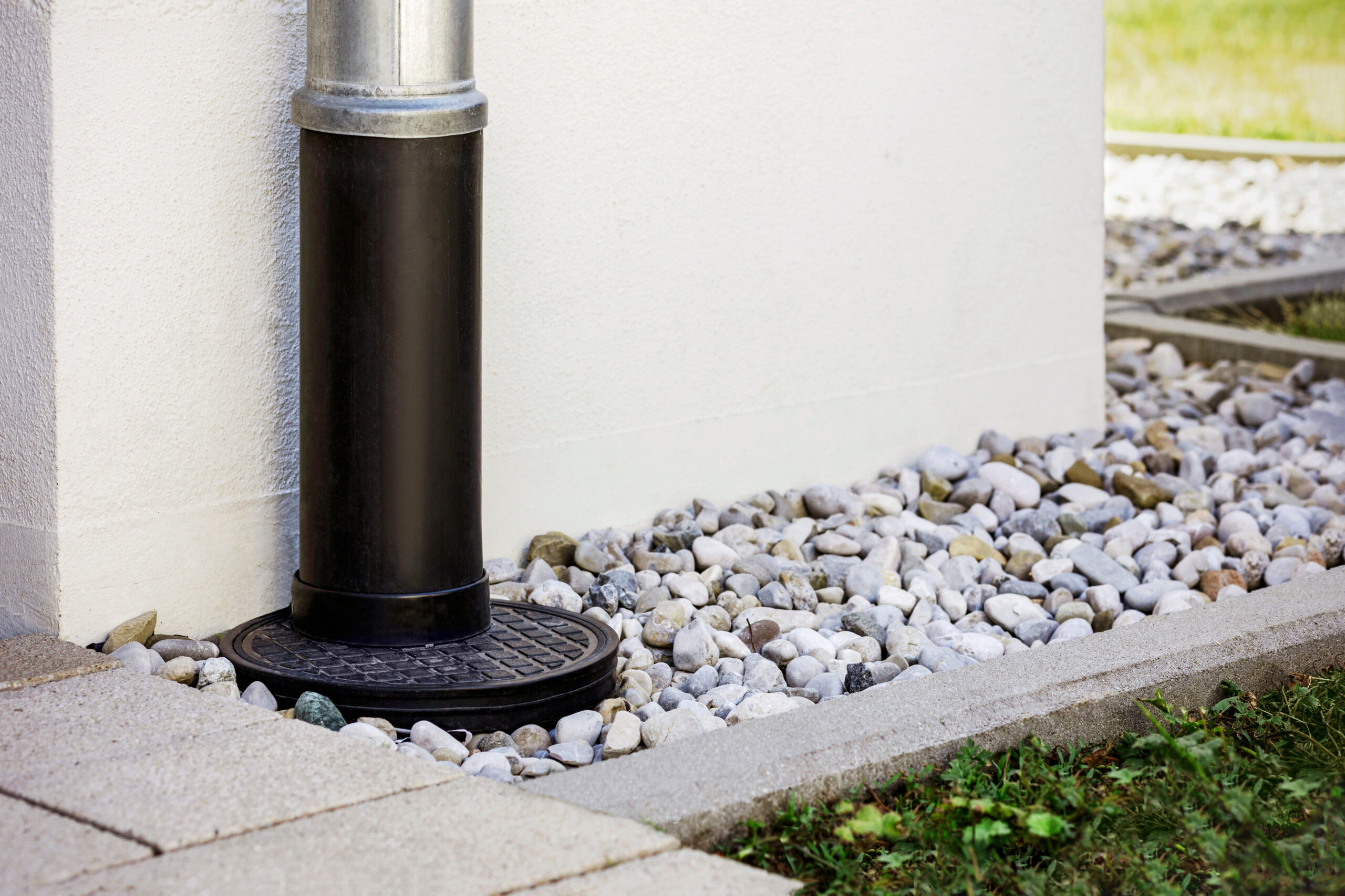 French Drain with Downspout Gutter Pipe around Building Facade. Runoff Drain System of Perimeter House. Modern Underground Gutter System.
